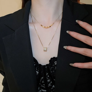 Close-up of 18k gold plated double layer necklace with sparkling cubic zirconia pendant
