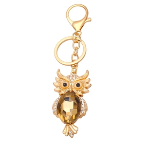 Golden owl keychain with brown crystal and sparkling rhinestones on a white background