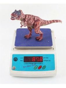 Detailed view of T-Rex model toy weighing 87.8g on an electronic scale for size reference