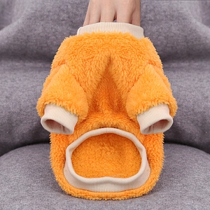Detail of bright orange lamb wool pet sweatshirt showing thick and fluffy fleece texture