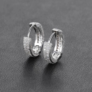 Macro detail of silver hoop earrings with full pave micro-set white zircon stones