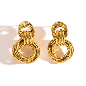 Detailed view of luxury gold titanium steel earrings with multi-layer hollow circular design