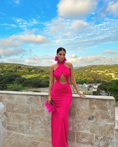 Detail of rose red backless halter dress featuring waist cutout and feathered accessories