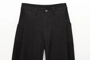 Dettaglio dei pantaloni in twill grigio scuro con focus su bottone in vita e tasche