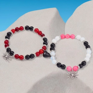 Detail of magnetic heart clasp connecting two beaded spider charms bracelets