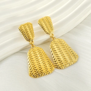 Macro view of 18k gold plated stainless steel earrings with woven herringbone texture