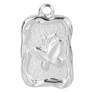 Detailed view of silver rectangular pendant with embossed butterfly and hammered texture