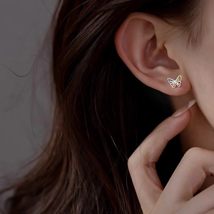 Elegant S999 sterling silver butterfly stud earrings with colorful gemstones worn by model