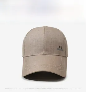 Detail of khaki twill baseball cap showing FS FASHION embroidery and reinforced wide brim