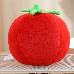 Close-up of soft plush tomato toy with green leaf detail and smooth velvet texture