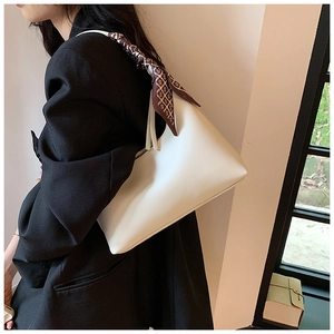 Minimalist white PU leather underarm bag with a decorative geometric printed silk scarf handle