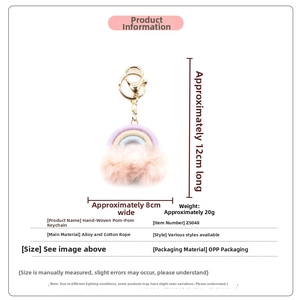 Detail of bohemian rainbow keychain with colorful cotton rope and soft pink pom poms