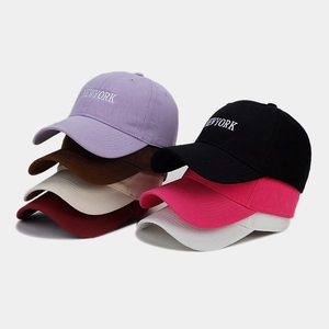 Detailed view of NEW YORK embroidered baseball caps in seven vibrant color options