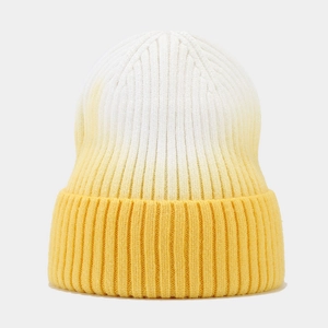 Detail view of tie-dye rib knit beanie with yellow gradient and thick folded cuff