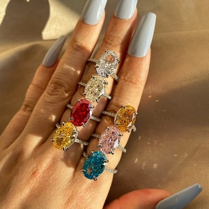 Close-up of S925 silver rings with colorful oval zircon stones and rainbow light reflections