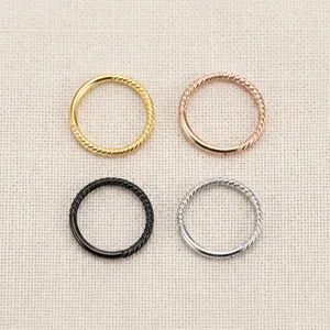 Twisted stainless steel hoop earrings in gold, rose gold, black, and silver finishes