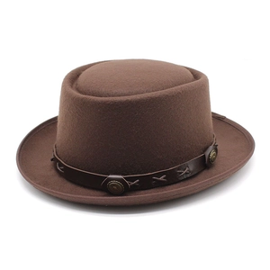 Detail of dark brown wool felt hat with leather band and metal buckle accents