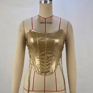 Detail of gold metallic corset top featuring boning structure and side lace-up design