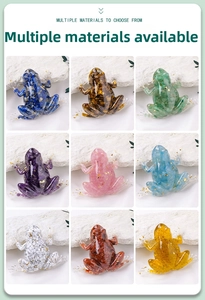 Nine colorful resin frog figurines filled with natural crystals and gold leaf on white stone