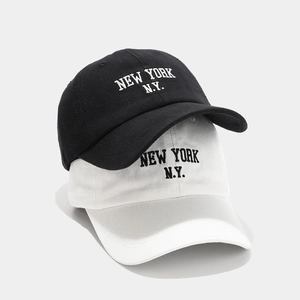 Detail of high-density cotton New York embroidery on black and white baseball caps