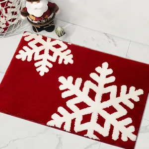 Detail of red Christmas rug with textured white snowflake patterns and plush pile texture