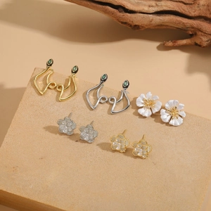 S925 silver needle camellia flower and snake zircon earrings set on stone tray