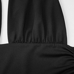 Detailed macro view of black fabric with pleated texture and subtle sheen on a summer dress