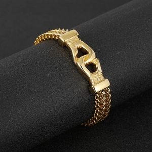 Detail view of bold gold titanium double dragon bone link chain bracelet for men