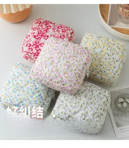 Macro detail of quilted floral storage bags in five pastel colors with white zippers