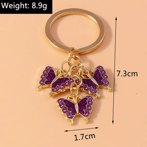 Detailed view of purple glitter butterfly keychain with 7.3cm height and 8.9g weight