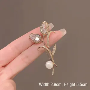 Elegant gold tulip brooch with sparkling zircons and a white pearl, 2.9cm x 5.5cm size