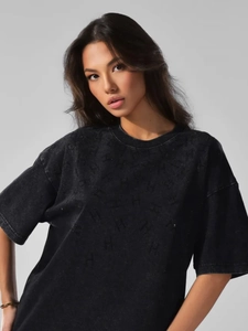 Close-up of vintage washed cotton T-shirt with all-over H-pattern texture and rhinestones