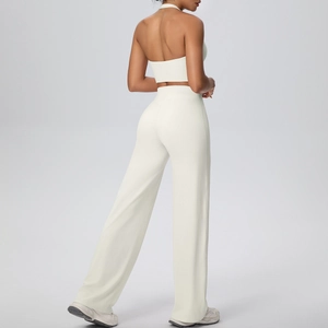 Back view of cream white halter neck sports bra and high-waist wide leg yoga pants set
