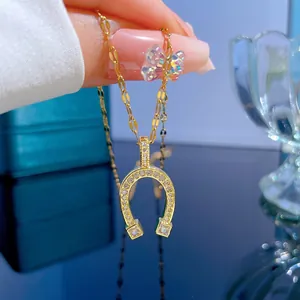 Macro shot of horseshoe pendant with micro-pave crystals on gold titanium chain