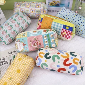 Floral quilted cotton pouches with zippers in various patterns for pens and cosmetics