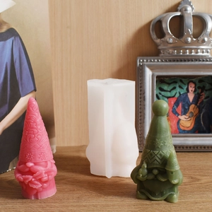 Detailed close-up of a 3D gnome silicone mold with finished Christmas gnomes featuring snowflake patterns