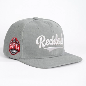 Gray flat brim snapback hat featuring Reckless embroidery and USA Sports badge details