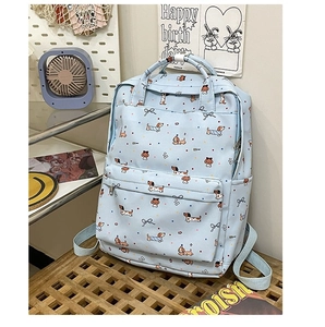 Detail of light blue backpack featuring dachshund dog prints and colorful polka dots