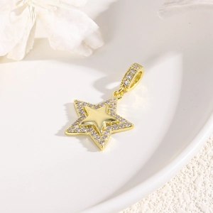 Close-up of a golden star pendant with sparkling rhinestones on white display