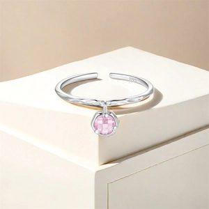 Macro detail of S925 sterling silver hammered texture ring with pink zircon pendant
