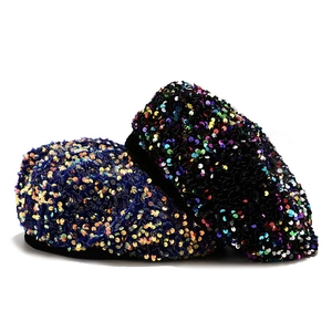 Close-up of velvet beret hats with colorful sparkling sequins in navy and black