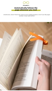 Detail of an orange automatic tracking bookmark clipped on a book for page marking
