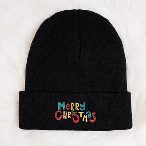Classic black knitted beanie with colorful Merry Christmas embroidery on white faux fur
