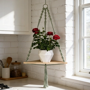 Handmade green macrame corner shelf with wooden triangle board for plant wall decor