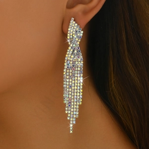 Detailed view of colorful rhinestone waterfall tassel earrings worn by a model