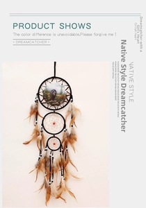 Detailed view of triple-ring dream catcher with black bear motif and natural feathers