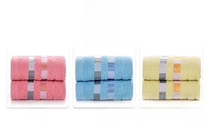 Detailed view of pink, blue and yellow striped cotton towels with soft terrycloth texture