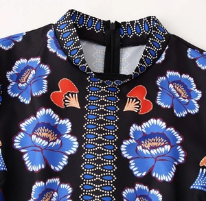 Detail of stand collar neckline with blue floral print and back zipper on dress