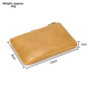 Detail view of a vintage leather coin purse with size specs and metal zipper closure