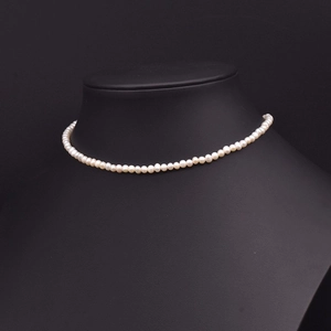 Elegant natural freshwater pearl necklace displayed on a black bust mannequin stand
